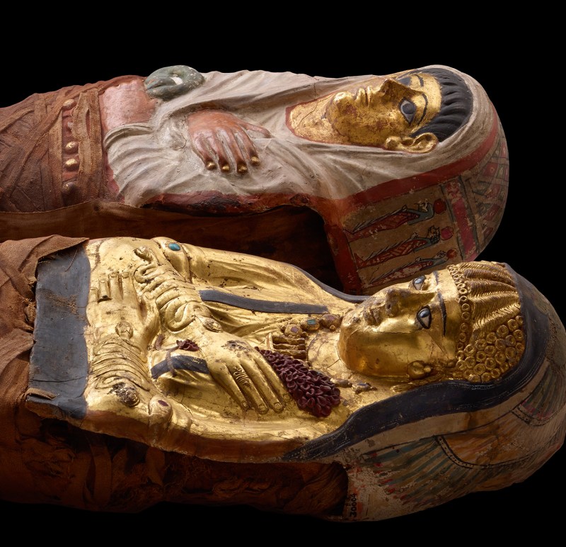 CT scanning of these two beautifully-gilded and decorated mummies of Ptolemaic Egypt revealed a young sister and brother. Both are portrayed wearing a mix of Greek fashions (like the golden girl’s curls) and Egyptian fashions.