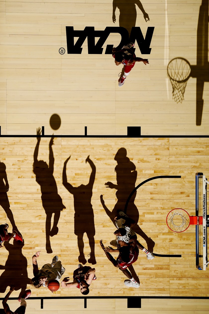 Ron Baker (31) shoots over Nick Zeisloft (2) as Hanner Mosquera-Perea (12) and Rashard Kelly (0) battle for position under basket at the NCAA 2015 Mens Basketball Tournament game with Wichita State vs. Indiana at the CenturyLink Center in Omaha, Nebraska, USA on March 20th of 2015. Greg Nelson executed this photograph without posing any of the subjects. World Press Photo 2016 Contest