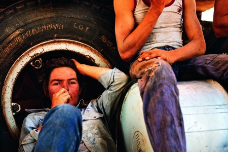 Resting in the shade of a tarpaulin. Jackaroo Malcolm Chillmon, 20, from Chippendale, New South Wales with Jillaroo Susan Gilmore from Brisbane, Queensland, and stationhand Mark Ashlin from Gulgung, New South Wales. (Balls and Bulldust by Hakan Ludwigson, publishd by Steidl)