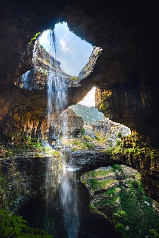 PIC BY RALPH AZAR/ CATERS NEWS - (PICTURED: The three bridge waterfall taken from inside the fall) - These stunning pictures of beautiful waterfalls will take your breath away. The mystical waterfall trickles down through unique circular rock formations, echoing around cavernous gorge. The incredible series of snaps were caught on camera by Ralph Azar and Jack Seikaly, from Beirut, Lebanon, at the Baatara Gorge waterfall, near Tannourine in northern Lebanon. Ralph, 28, said: I tried lots of different angles  I wanted to show the grandeur of this place without actually paying attention to where I was going. SEE CATERS COPY.