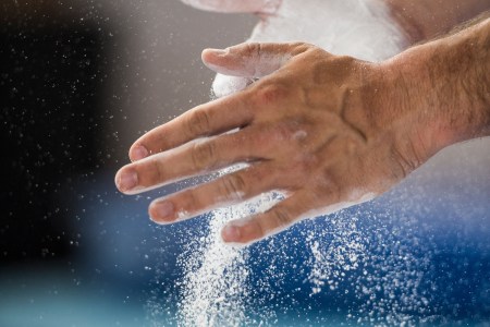 Male gymnast preparing for performance on the side horse
