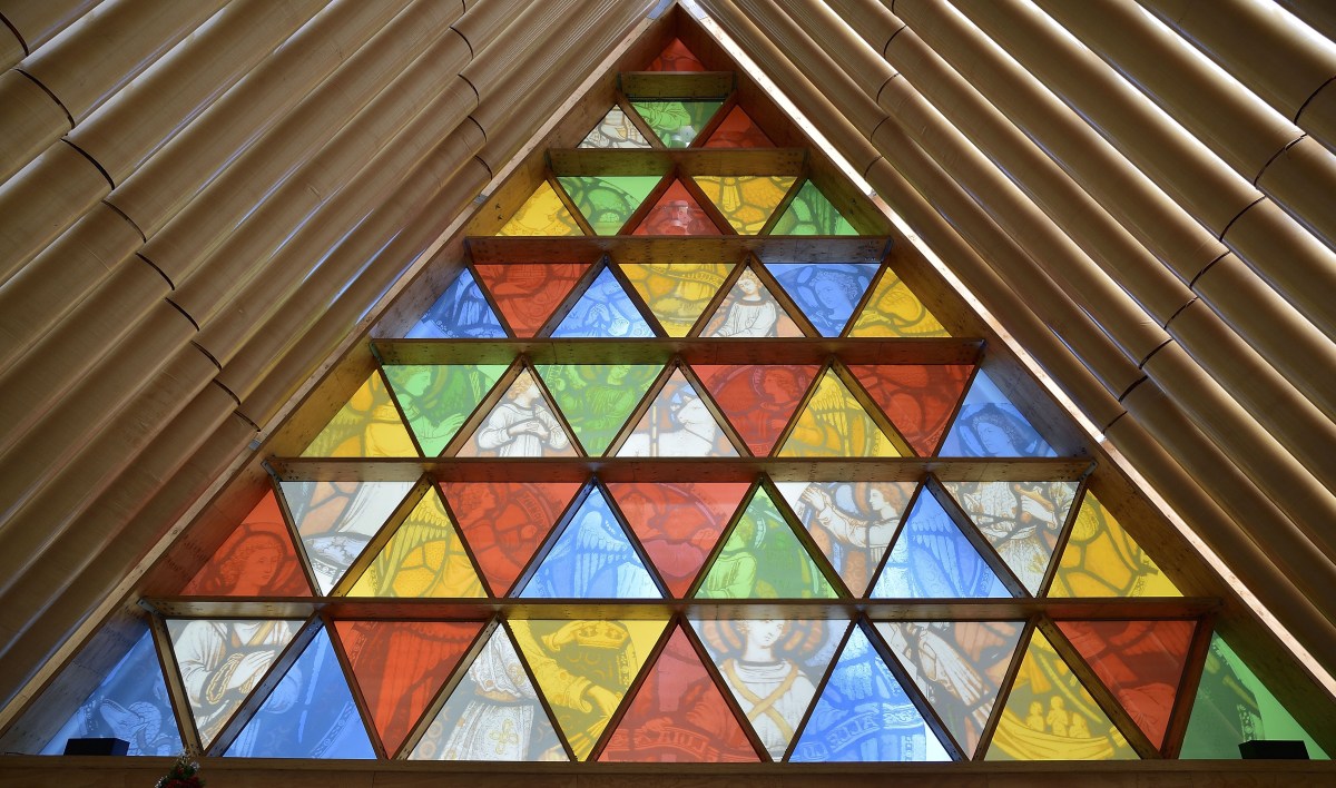 This photo taken on December 30, 2014 shows the front window that incorporates images from Christchurch Cathedral's original rose window in Christchurch's "Cardboard Cathedral", designed by award-winning Japanese architect Shigeru Ban.  The structure, which is a temporary replacement for the 1881 Anglican cathedral destroyed in the February, 2011 quake with killed 185 people, is an A-frame building constructed with weather-proofed cardboard tubes.      AFP PHOTO / MARTY MELVILLE        (Photo credit should read Marty Melville/AFP/Getty Images)