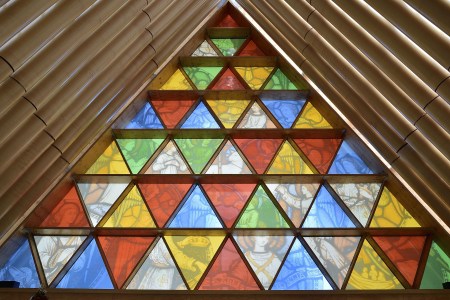 This photo taken on December 30, 2014 shows the front window that incorporates images from Christchurch Cathedral's original rose window in Christchurch's "Cardboard Cathedral", designed by award-winning Japanese architect Shigeru Ban.  The structure, which is a temporary replacement for the 1881 Anglican cathedral destroyed in the February, 2011 quake with killed 185 people, is an A-frame building constructed with weather-proofed cardboard tubes.      AFP PHOTO / MARTY MELVILLE        (Photo credit should read Marty Melville/AFP/Getty Images)