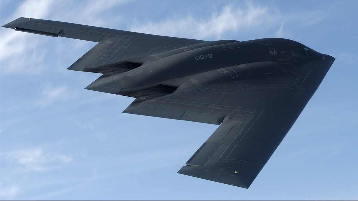 IN FLIGHT - MAY 8:  The bat-shaped B-2 stealth bomber with its flying wing design flies over Whiteman Air Force Base May 8, 2003 near Knob Noster, Missouri.  Whiteman is the home of the B-2's, of which there are only about twenty.  Each B-2 is worth about $2 million USD.  With the Wright Brothers' historic flight celebrating its centennial in 2003, the world is now poised on the threshold of a new age in aviation, one where super-sonic jets refuel in flight, unmanned aerial vehicles track objects with astonishing accuracy, and airliners are maneuvered at times with minimal human participation.  The computer age is about to revolutionize aviation and the United States is unquestionably ahead of the curve in this revolution.  (Photo by Joe McNally/Getty Images)