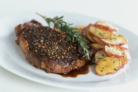 Rib-eye steak au poivre with balsamic reduction. Recipe by Lori W. Powell. (Photo by Romulo Yanes/Condé Nast via Getty Images)