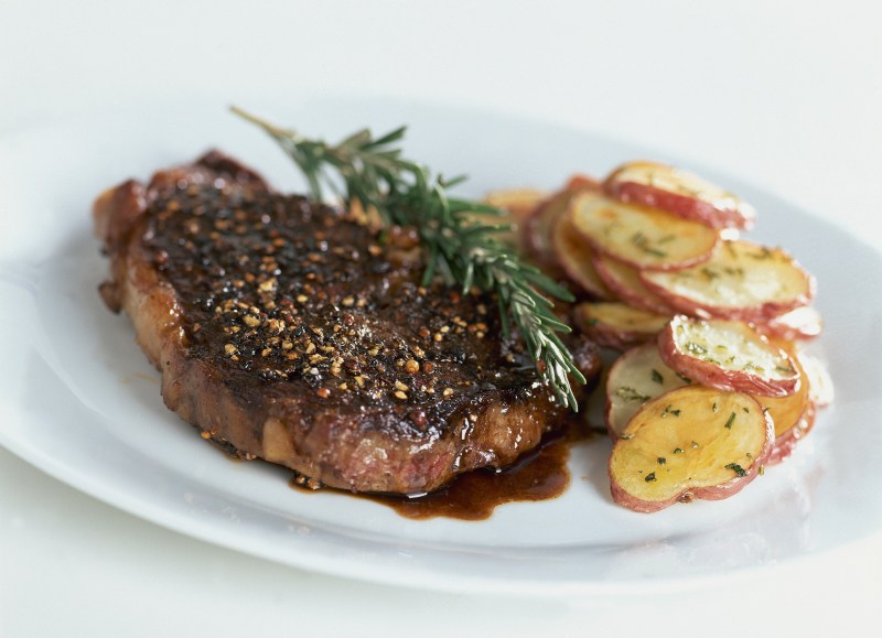 Rib-eye steak au poivre with balsamic reduction. Recipe by Lori W. Powell. (Photo by Romulo Yanes/Condé Nast via Getty Images)