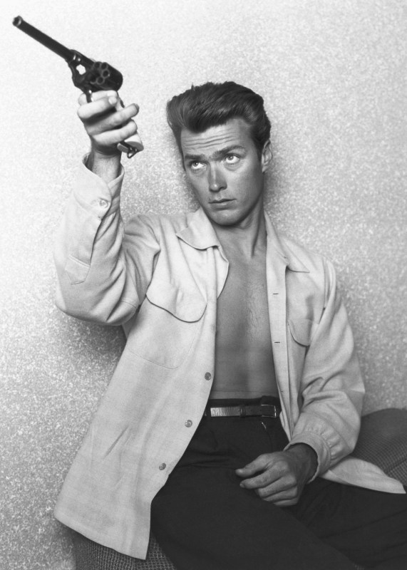 LOS ANGELES - JUNE 1: Actor Clint Eastwood checks his gun at home on June 1, 1956 in Los Angeles, California. (Photo by Michael Ochs Archives/Getty Images)