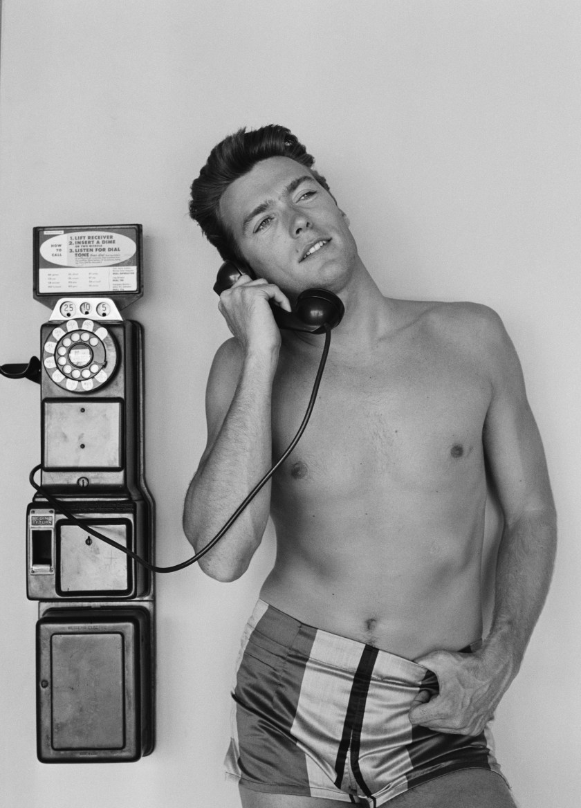 LOS ANGELES - JUNE 1: Actor Clint Eastwood talks on a pay phone outside his home on June 1, 1956 in Los Angeles, California. (Photo by Michael Ochs Archives/Getty Images)