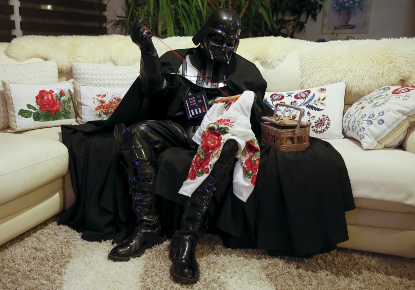 Darth Mykolaiovych Vader, who is dressed as the 'Star Wars' character Darth Vader, poses for a picture as he does embroidery at his apartments in Odessa, Ukraine, December 2, 2015. Darth Vader was bent on galactic domination, but his Ukrainian namesake enjoys more mundane pursuits: local politics, walking the family dog and a spot of embroidery. The Ukrainian citizen, who has changed his name to Darth Mykolaiovych Vader, ran for the post of local mayor in October, his political backers dressed as Stormtroopers. In his trademark black outfit, he is a regular sight around Odessa, a major port city on southern Ukraine's Black Sea coast. REUTERS/Valentyn Ogirenko PICTURE 16 OF 22 - SEARCH "VALENTYN VADER" FOR ALL IMAGES TPX IMAGES OF THE DAY TPX IMAGES OF THE DAY - RTX1Y83T