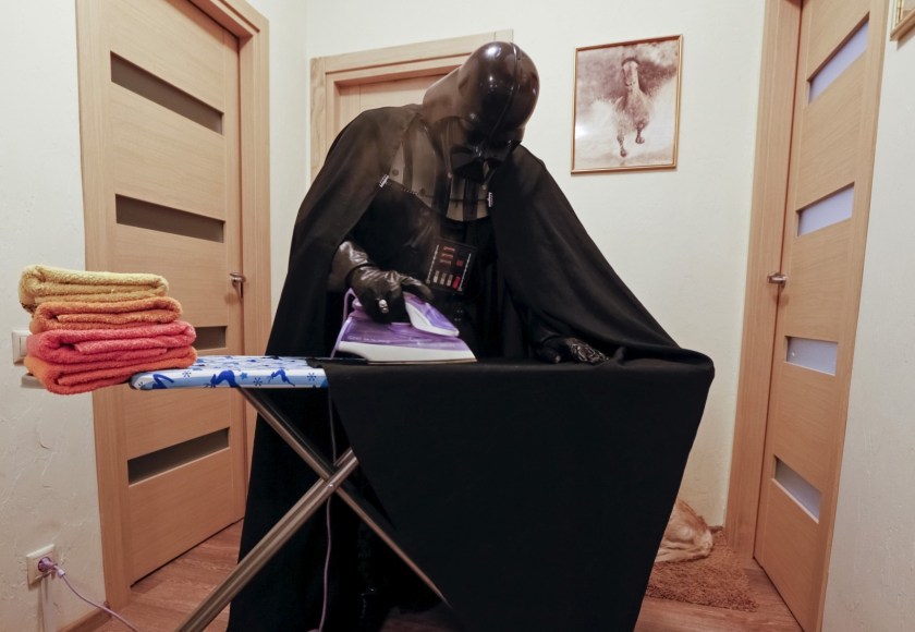 Darth Mykolaiovych Vader, who is dressed as the 'Star Wars' character Darth Vader, poses for a picture as he irons his cloak at his apartments in Odessa, Ukraine, December 2, 2015. Darth Vader was bent on galactic domination, but his Ukrainian namesake enjoys more mundane pursuits: local politics, walking the family dog and a spot of embroidery. The Ukrainian citizen, who has changed his name to Darth Mykolaiovych Vader, ran for the post of local mayor in October, his political backers dressed as Stormtroopers. In his trademark black outfit, he is a regular sight around Odessa, a major port city on southern Ukraine's Black Sea coast. REUTERS/Valentyn Ogirenko PICTURE 13 OF 22 - SEARCH "VALENTYN VADER" FOR ALL IMAGES - RTX1Y83Z