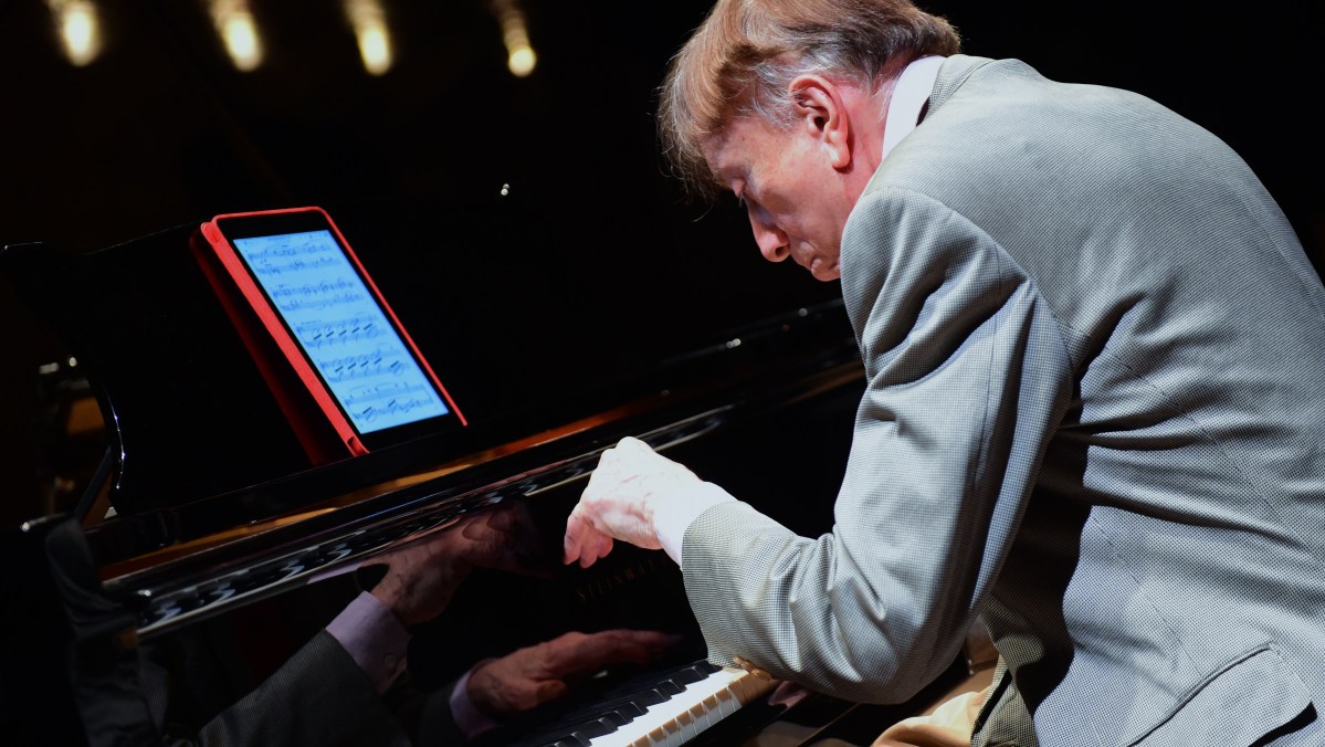 Hungarian pianist Tamas Vasary plays from a tablet with a sheet of a classical music in the concert hall of Budapest Music Center. (Attila Kisbenedek/AFP/Getty Images)
