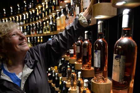 A woman looks at bottles of wine as she visits La Cite du Vin (Wine Museum) as it opens its doors to the public in Bordeaux on June 1, 2016.
La Cite du Vin opened its doors to the public on June 1. The 13 350 m2 compound offers thematics areas about the history and civilisations of wine around the world with digital and sensory exhibits. / AFP / MEHDI FEDOUACH        (Photo credit should read MEHDI FEDOUACH/AFP/Getty Images)