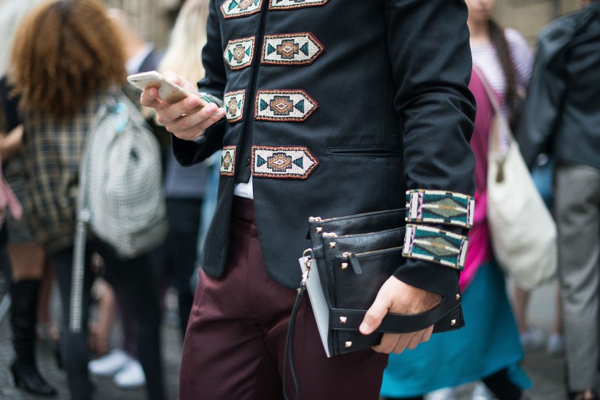 A guest wears Valentino jacket and clutch after the Valentino show at Hotel Salomon. (Vanni Bassetti/Getty Images)