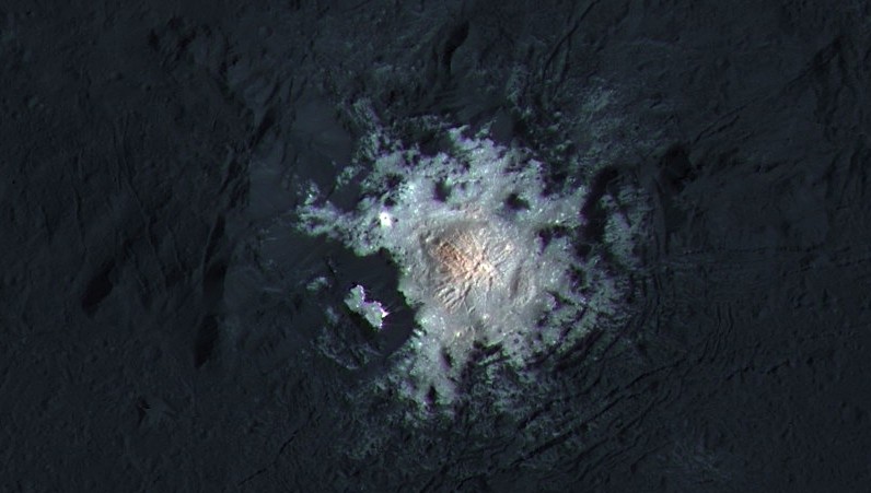 The bright spots of Occator Crater are shown in enhanced color in this view from NASA's Dawn spacecraft. Such views can be used to highlight subtle color differences on Ceres' surface.(NASA/JPL-Caltech/UCLA/MPS/DLR/IDA/PSI/LPI)