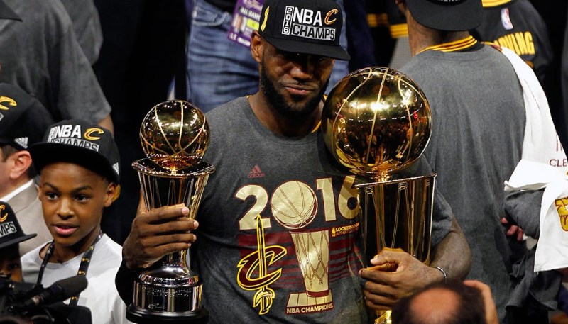 June 19, 2016; Oakland, CA, USA; Cleveland Cavaliers forward LeBron James (23) celebrates with the Larry O'Brien championship and Bill Russell MVP trophies following the 93-89 victory against the Golden State Warriors in game seven of the NBA Finals at Oracle Arena. Mandatory Credit: Cary Edmondson-USA TODAY Sports - RTX2H3O6