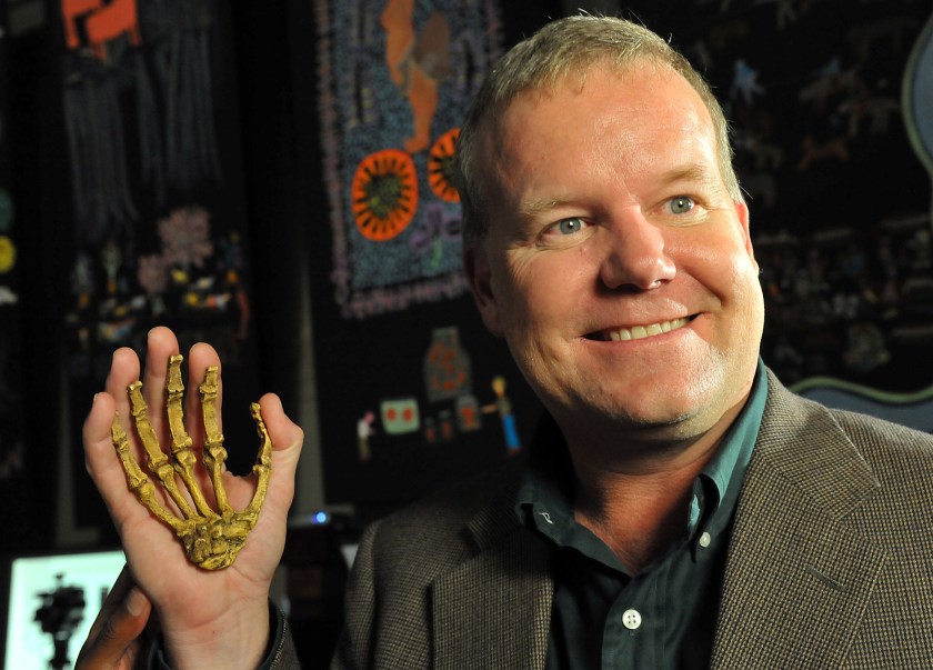 Professor Lee Berger, an American who is a professor at South Africa's University of the Witwatersrand, poses with the reconstructed hand of a hominin he discovered, during the unveiling of this Sediba Fossil in Johannesburg, on September 8, 2011.