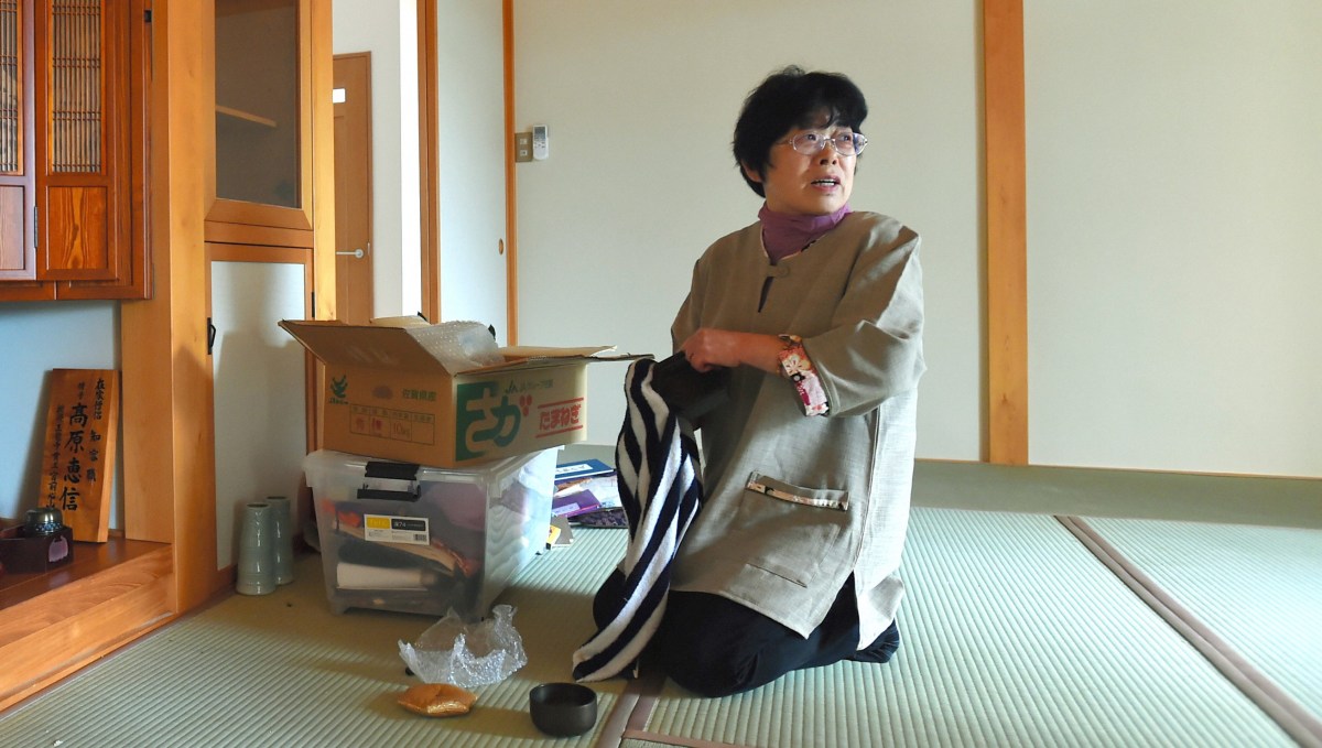 Kaneko Takahara, 66, sits on newly furbished tatami mat as she returns her home at former no-go zone of the crippled Fukushima Daiichi Nuclear Power Plant in Naraha. (The Asahi Shimbun via Getty Images)