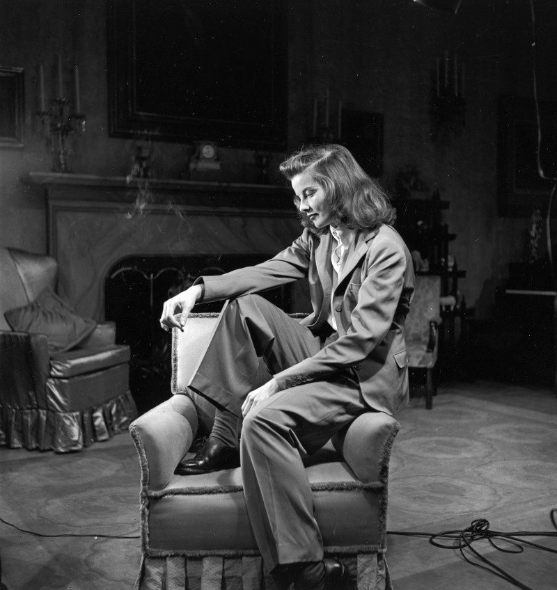 Portrait of actress Katharine Hepburn sitting on arm of chair, smoking. (Alfred Eisenstaedt/The LIFE Picture Collection/Getty Images)