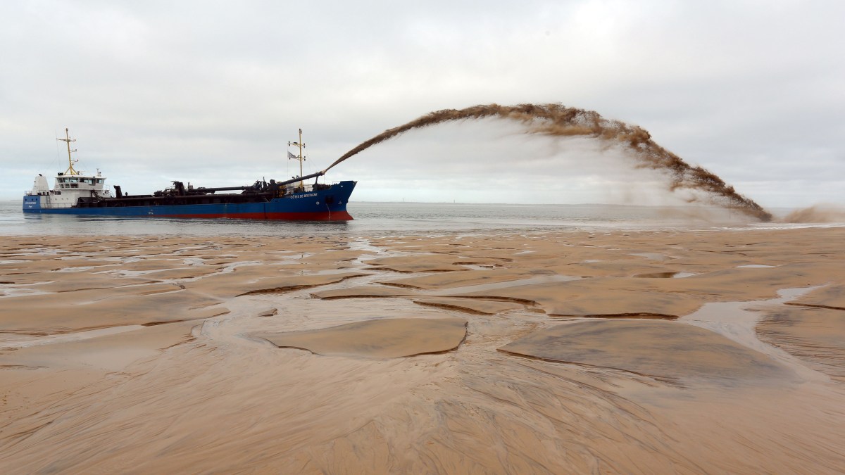 The dredger "Cotes de Bretagne" shoots sand onto a beach of Pyla-sur-Mer in La Teste-de-Buch in Arcachon Bay.
The boat, from Brittany, pumps sand from offshore sand bars before shooting it back onto beaches using a technique known as "the rainbow", in an effort to fight against erosion.  (Nicolas Tucat/AFP/Getty Images)