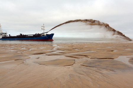 The dredger "Cotes de Bretagne" shoots sand onto a beach of Pyla-sur-Mer in La Teste-de-Buch in Arcachon Bay.
The boat, from Brittany, pumps sand from offshore sand bars before shooting it back onto beaches using a technique known as "the rainbow", in an effort to fight against erosion.  (Nicolas Tucat/AFP/Getty Images)