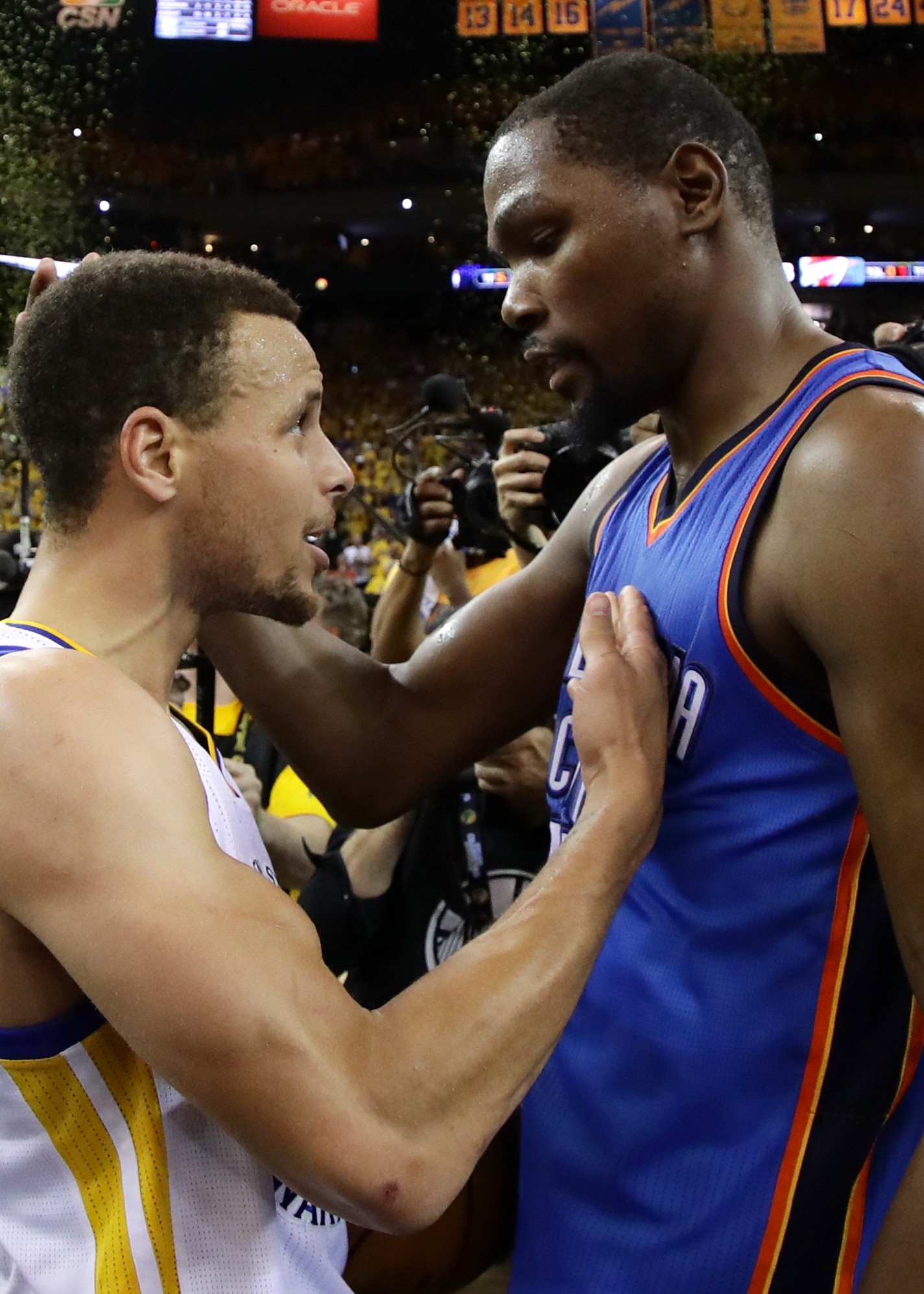 OAKLAND, CA - MAY 30:  Stephen Curry #30 of the Golden State Warriors speaks with Kevin Durant #35 of the Oklahoma City Thunder after their 96-88 win in Game Seven of the Western Conference Finals during the 2016 NBA Playoffs at ORACLE Arena on May 30, 2016 in Oakland, California. NOTE TO USER: User expressly acknowledges and agrees that, by downloading and or using this photograph, User is consenting to the terms and conditions of the Getty Images License Agreement.  (Photo by Ezra Shaw/Getty Images)
