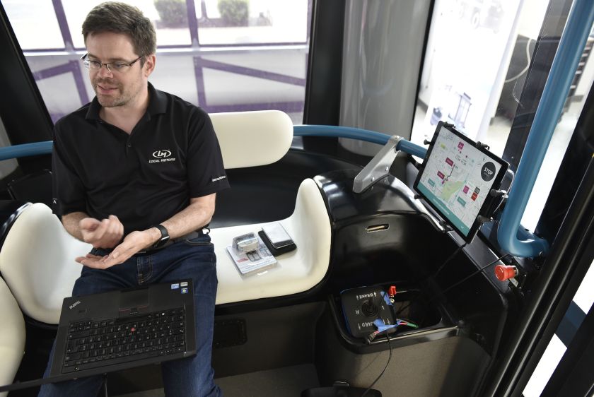 A programer works on an "Olli" autonomous shuttle at the Local Motors facility in the National Harbor, Maryland on June 16, 2016. The electric self-driving shuttle is a partnership between Local Motors and IBM, using IBM's Watson supercomputer. (Mandel Ngan/AFP/Getty Images)