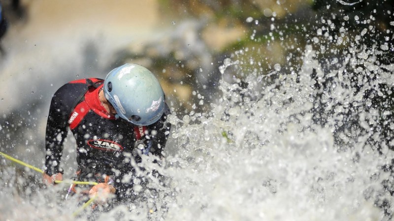 Canyoning sports Enthusiast playing on waterfall during 2nd National Canyoning Randezvous (NCR 2016) oraganized by Nepal Canyoning Association at Chahare Jharana (90 meters), Thanapati, Nuwakot, Nepal on June 3, 2016. Canyoning (known as canyoneering in the U.S.); Canyoning is a new adventure in water sport geared to the ultimate sports enthusiast. It is an activity that involves abseiling; sliding; jumping; swimming; and climbing down waterfalls through steep canyon walls to deep pools. (Photo by Narayan Maharjan/NurPhoto via Getty Images)