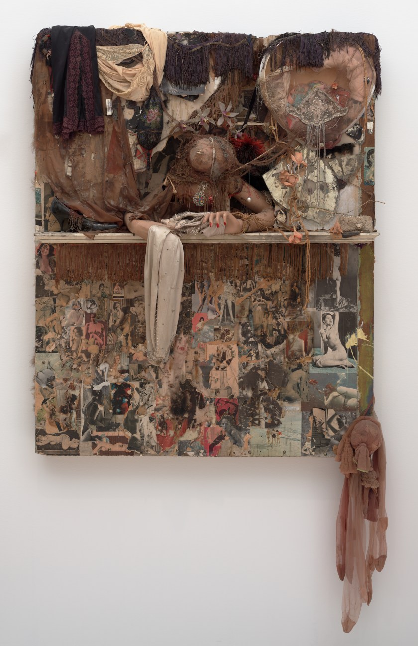 "Looking Glass," 1964. Made with mannequin arms, dried blowfish, painted wood, glass, fringe, shoe, cardboard, cut and pasted printed papers, paint, nylon, fabric, jewelry, beads, string, doll voice box, fur, artificial flowers, feathers, garter clip, tinsel, and metal on Masonite (Ben Blackwell)