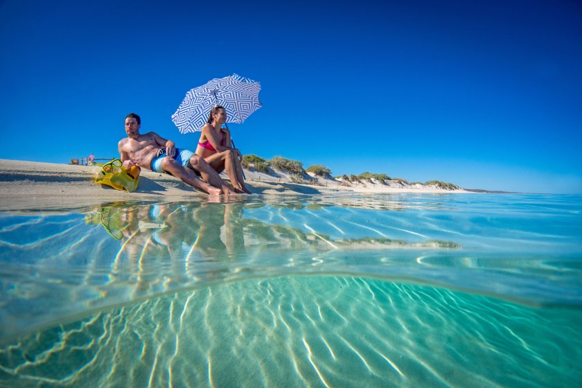 Couple relaxing on beach at Turquoise Bay (Courtesy Western Australia Tourism)