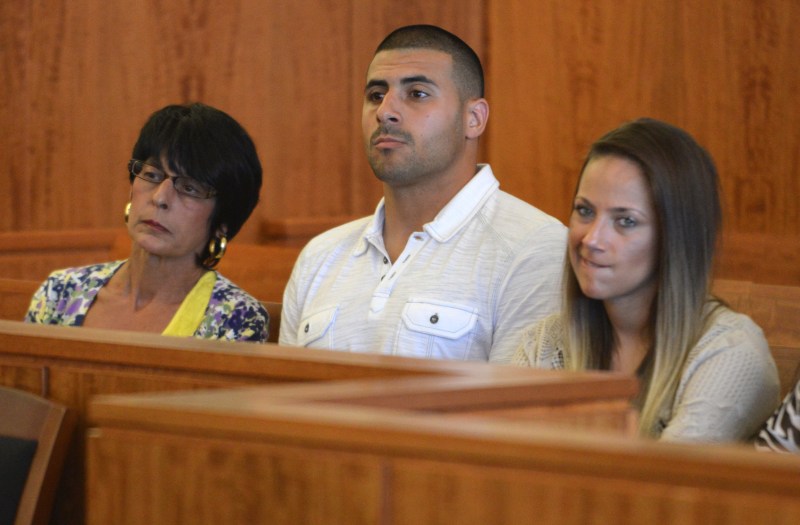 Aaron Hernandez' mother Terri Hernandez, left, brother D.J. Hernandez, center, and an unidentified woman listen to proceedings during a hearing in Fall River superior court Monday July 7, 2014, in Fall River. Mass. The Judge agreed that Hernandez could be moved to a jail closer to Boston while he awaits his trial for the murder of Odin Lloyd. (AP Photo/The Boston Globe, Josh Reynolds, Pool)