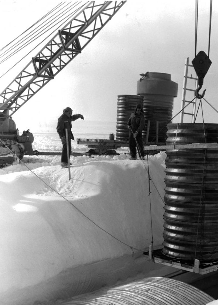 A crane lowers a hatch into a lateral trench of the permanent camp at Camp Century in Greenland. (Photo by Pictorial Parade/Archive Photos/Getty Images)