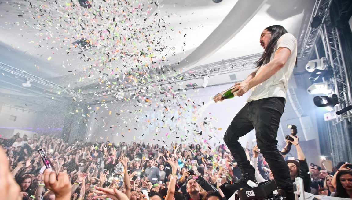 LOS ANGELES, CA - JANUARY 18:  DJ Steve Aoki sprays the audience with champagne at his record release event celebrating "Wonderland" at SupperClub Los Angeles on January 18, 2012 in Los Angeles, California.  (Photo by Chelsea Lauren/Getty Images)