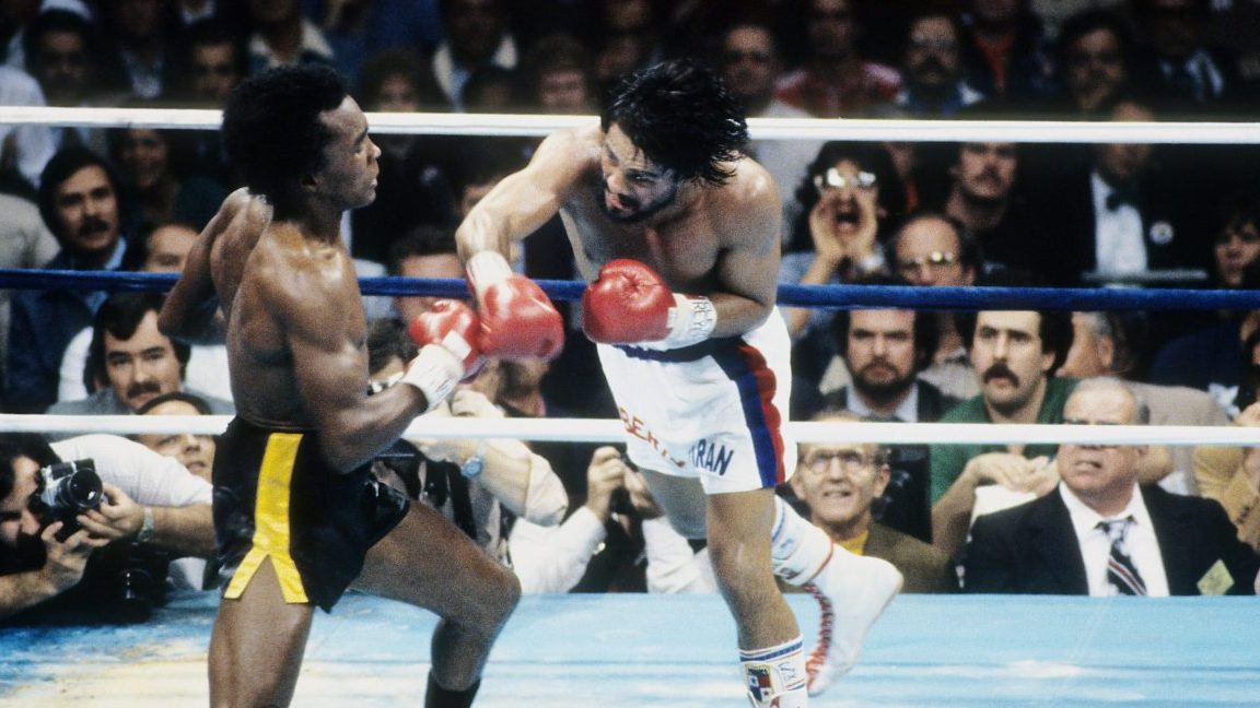 NEW ORLEANS - NOVEMBER 25,1980: Roberto Duran (R) leaps to land the punch against Sugar Ray Leonard during the fight at the Superdome in New Orleans, Louisiana. Sugar Ray Leonard  won the WBC welterweight title by a TKO 8. (Photo by: The Ring Magazine/Getty Images)