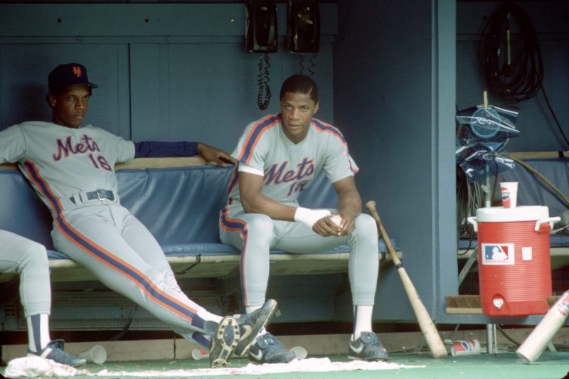 PITTSBURGH - JUNE 1988: Pitcher Dwight Gooden (L) and outfielder Darryl Strawberry of the New York Mets in the dugout during a game against the Pittsburgh Pirates at Three Rivers Stadium in June 1988 in Pittsburgh, Pennsylvania. (Photo by George Gojkovich/Getty Images)