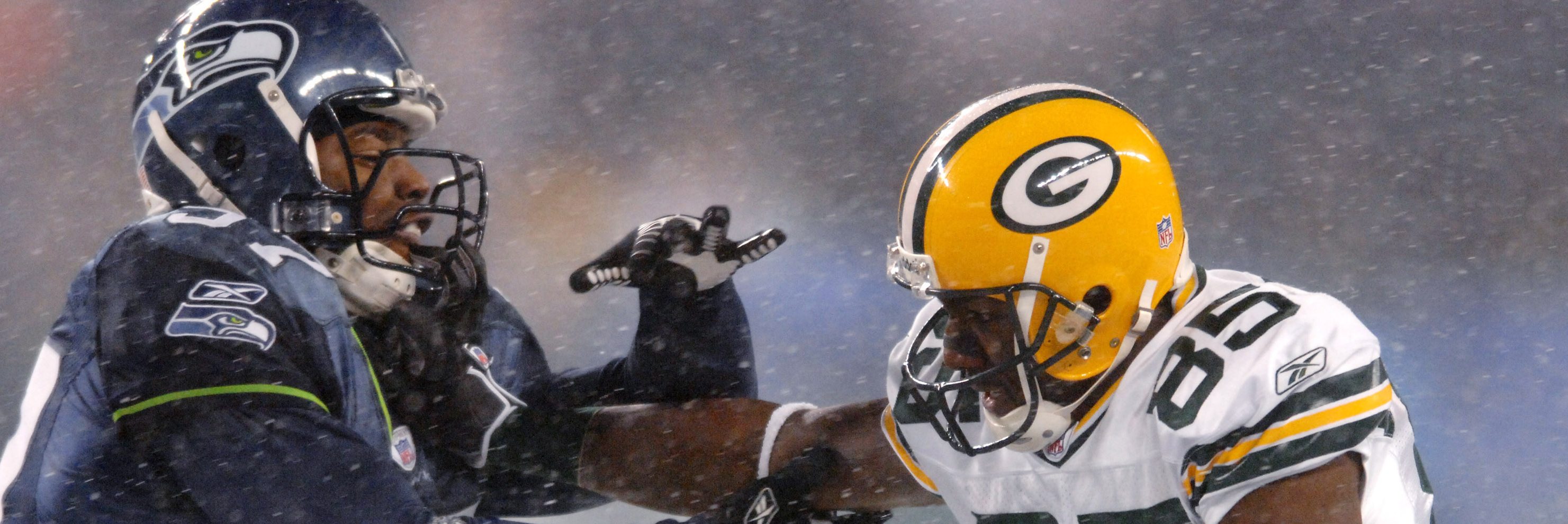 Packers receiver Greg Jennings straight arms Seahawks linebacker Kevin Bentley during a snowy Monday Night Football game between the Green Bay Packers and the Seattle Seahawks at Qwest Field in Seattle, Washington on November 27, 2006. (Kirby Lee/NFLPhotoLibrary)