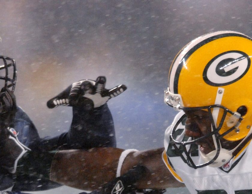 Packers receiver Greg Jennings straight arms Seahawks linebacker Kevin Bentley during a snowy Monday Night Football game between the Green Bay Packers and the Seattle Seahawks at Qwest Field in Seattle, Washington on November 27, 2006. (Kirby Lee/NFLPhotoLibrary)