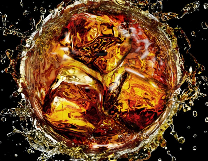Icecube splashing into cocktail