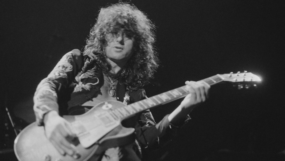 Guitarist Jimmy Page performing with British heavy rock group Led Zeppelin, at Earl's Court, London, May 1975. The band were initially booked to play three nights at the venue, from 23rd to 25th May, but due to public demand, two more concerts were later added, for 17th and 18th May. Total ticket sales were 85,000. (Photo by Michael Putland/Getty Images)