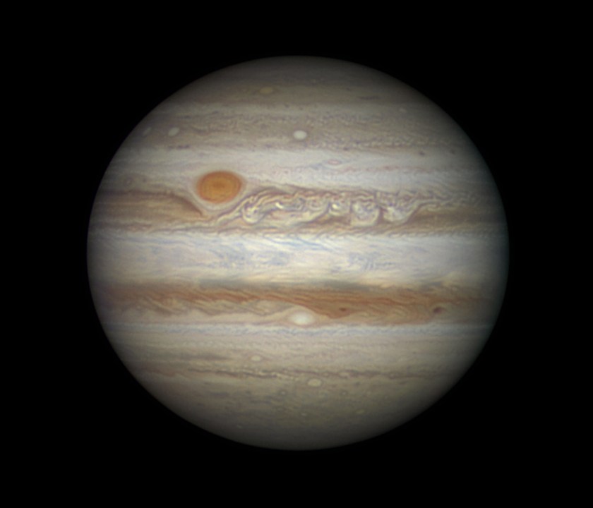 Looming in the night sky, tempestuous storms are visible across the face of the largest planet in our Solar System, Jupiter. The Great Red Spot - a raging storm akin to a hurricane on Earth - stands out in a deep orange from the hues of browns surrounding it. (Damian Peach)