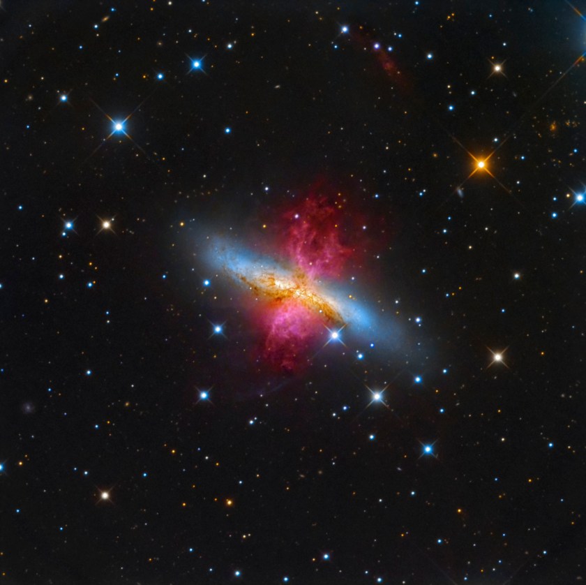 About 12 million light years away from our planet, lays the starburst galaxy M82, also known as the Cigar Galaxy. In a show of radiant red, the superwind bursts out from the galaxy, believed to be the closest place to our planet in which the conditions are similar to that of the early Universe, where a plethora of stars are forming. (Leonardo Orazi)