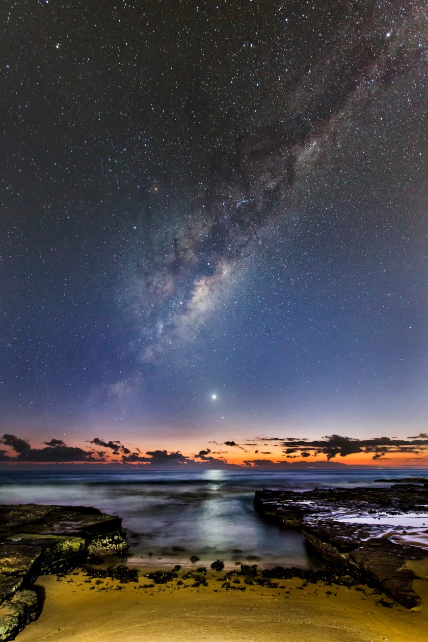 During the seldom-seen alignment of the five planets in February 2016, Venus, Mercury and the Milky Way rose an hour before sunrise, and appear to be fleeing its early glow, overlooking Turrimeta Beach, Australia. (Ivan Slade)