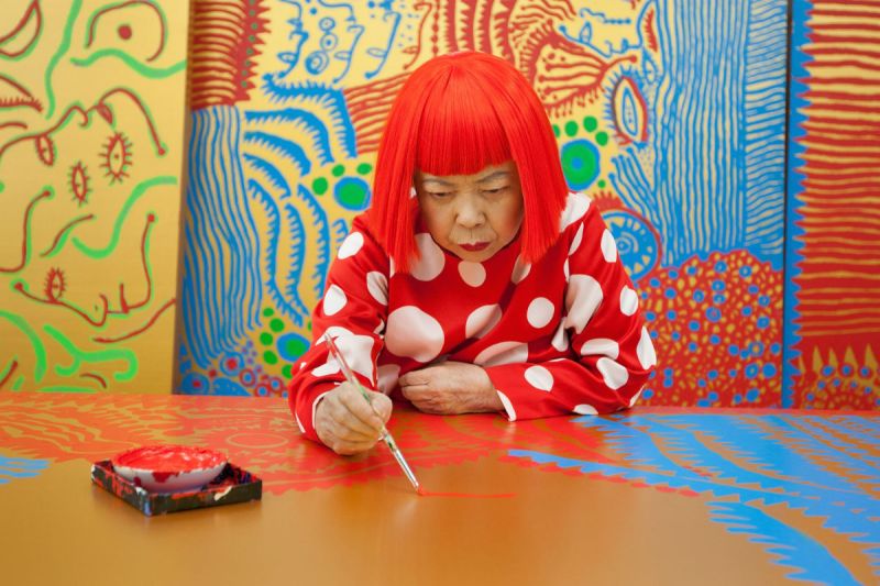 TOKYO, JAPAN - JANUARY 25: Japanese artist Yayoi Kusama sits working on a new painting, in front of other newly finished paintings in her studio, on January 25, 2012 in Tokyo, Japan. Yayoi Kusama, who suffers from mental health problems and lives in a hospital near her studio, is one of today's most highly revered and popular of Japanese artists. She is one of the world's top selling living female artists breaking records in the millions. A major retrospective of her work is on display at Tate Modern in London through June 5, 2012. (Photo by Jeremy Sutton-Hibbert/Getty Images)