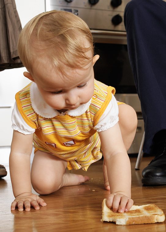 Child eating off floor. (Getty Images)