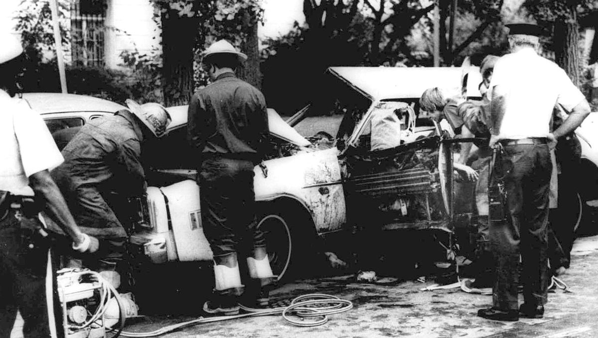 Firemen remove victims from a car shattered by a bomb blast on Embassy Row in Washington, D.C. Sept. 21, 1976. Orlando Letelier, former Chilean ambassador to the U.S., and Ronne Karpen Moffitt, his aide, were both killed in the blast.  (AP Photo)