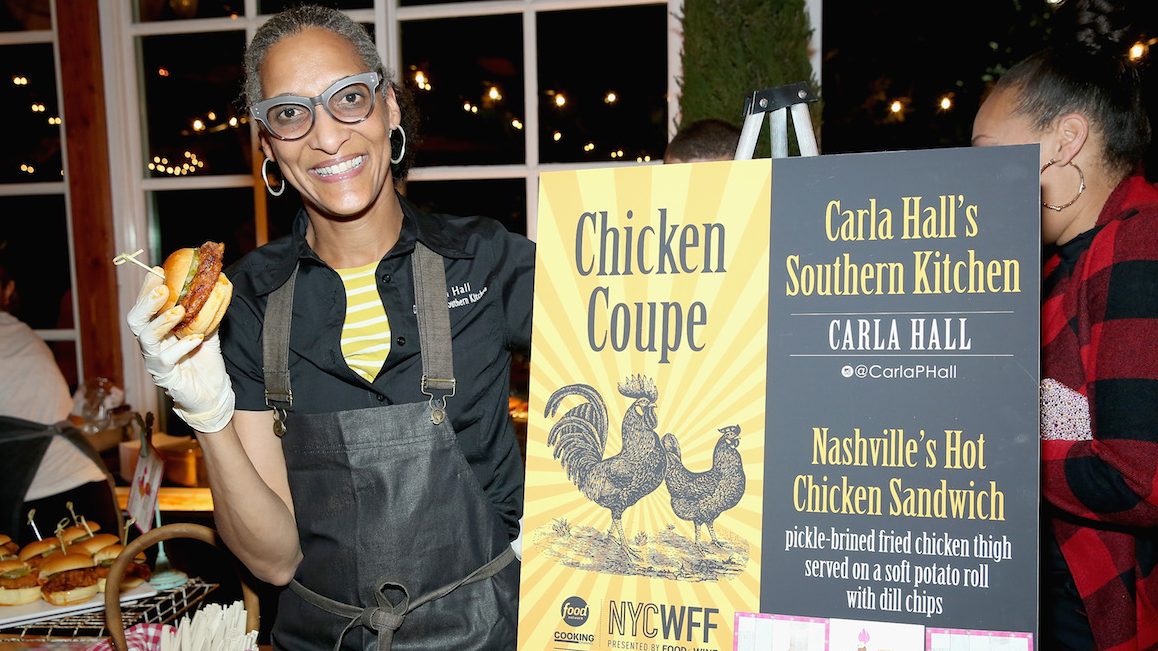 NEW YORK, NY - OCTOBER 15:  Carla Hall, Co-host of The Chew, and owner of Carla Halls Southern Kitchen poses with her dish; Nashville's Hot Chicken Sandwich at Chicken Coupe hosted by Whoopi Goldberg during Food Network & Cooking Channel New York City Wine & Food Festival presented by FOOD & WINE at The Loeb Boathouse on October 15, 2015 in New York City.  (Photo by Monica Schipper/Getty Images for NYCWFF)