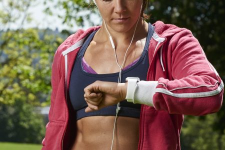 Portrait of a woman in sportswear checking an Apple Watch Sport, taken on May 21, 2015. (Photo by Joseph Branston/Future Publishing via Getty Images)