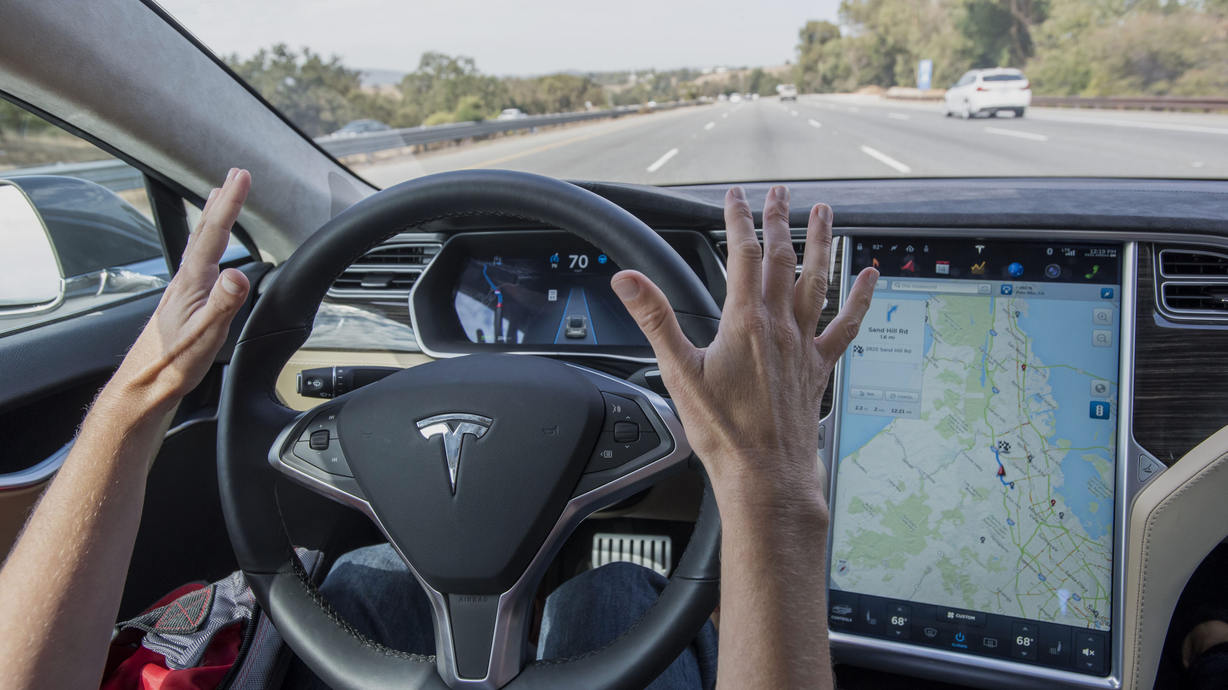 A member of the media test drives a Tesla Motors Inc. Model S car equipped with Autopilot in Palo Alto, California, U.S., on Wednesday, Oct. 14, 2015. (David Paul Morris/Bloomberg via Getty Images)