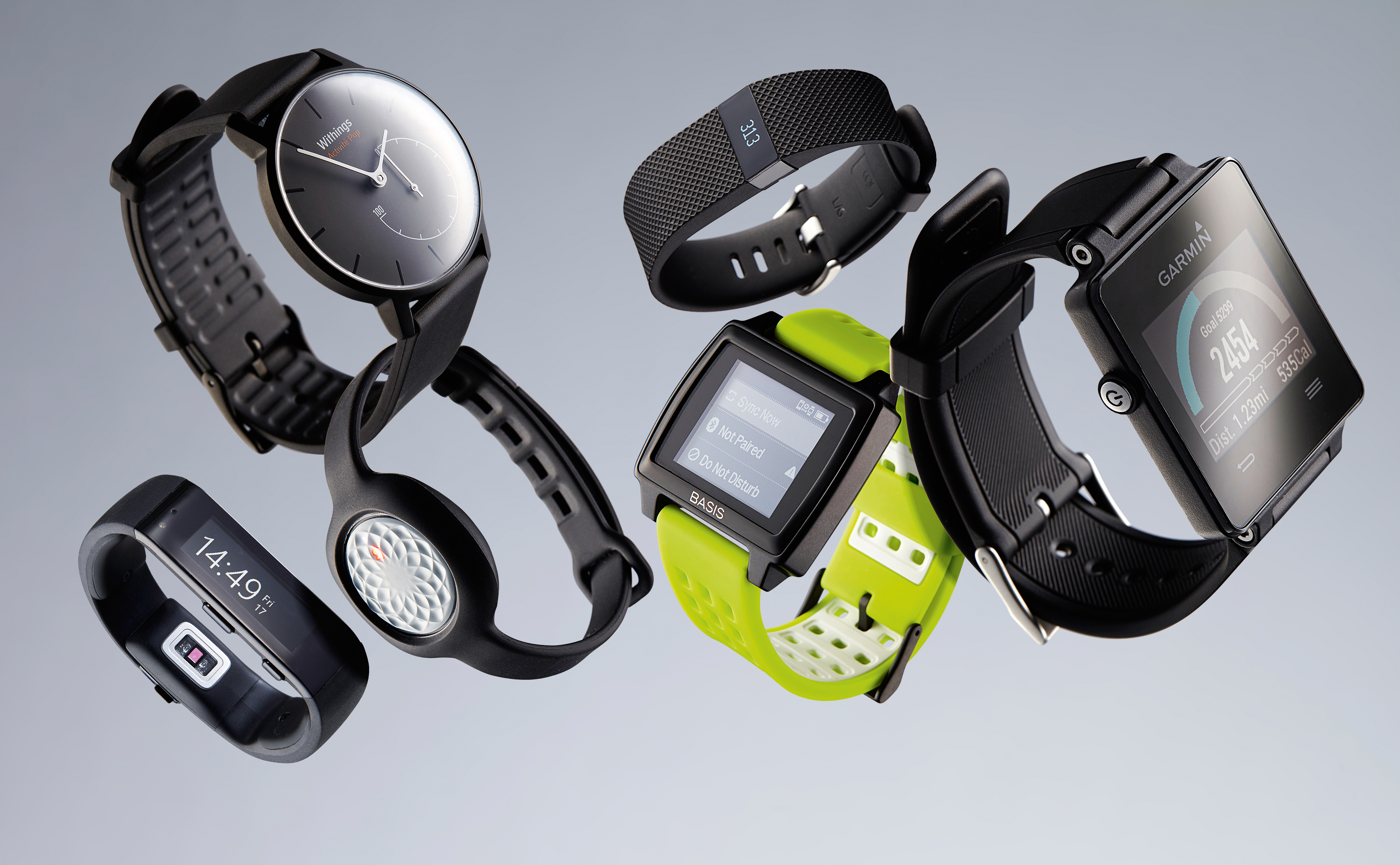 A selection of wearable fitness trackers, including (L-R) a Microsoft Band, Withings Activite Pop, Jawbone Up Move, Fitbit Charge HR, Basis Peak and a Garmin Vivoactive, taken on April 23, 2015. (Joby Sessions/T3 Magazine via Getty Images)