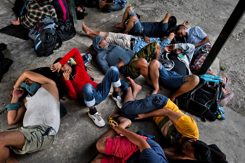 Nepalese immigrants, heading to the southern U.S. border, lie exhausted on the ground in the border checkpoint after crossing the jungle of Darién gap on January 28, 2015 in Darien, Panama. (Jan Sochor/Latincontent/Getty Images)