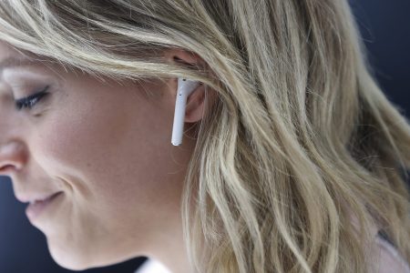An attendee wears an Apple AirPods during a launch event on September 7, 2016 in San Francisco, California. Apple Inc. unveiled the latest iterations of its smart phone, the iPhone 7 and 7 Plus, the Apple Watch Series 2, as well as AirPods, the tech giant's first wireless headphones. (Stephen Lam/Getty Images)